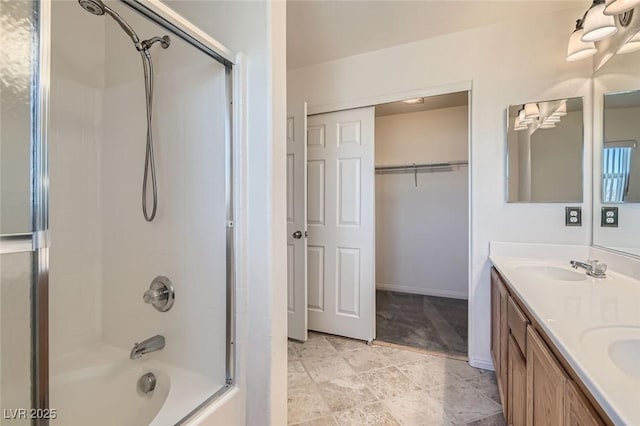 bathroom featuring vanity and bath / shower combo with glass door