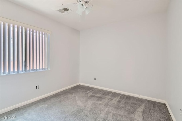 spare room featuring a wealth of natural light, carpet, and ceiling fan