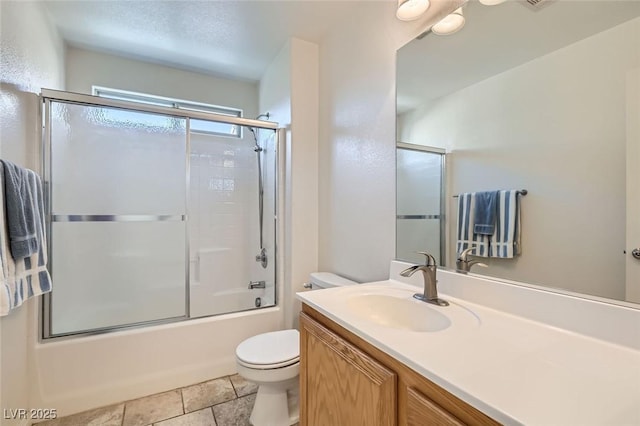 full bathroom featuring tile patterned flooring, vanity, enclosed tub / shower combo, and toilet