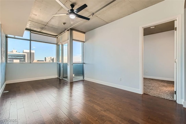 spare room featuring dark hardwood / wood-style floors and ceiling fan