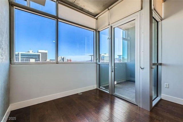 unfurnished room with dark hardwood / wood-style flooring