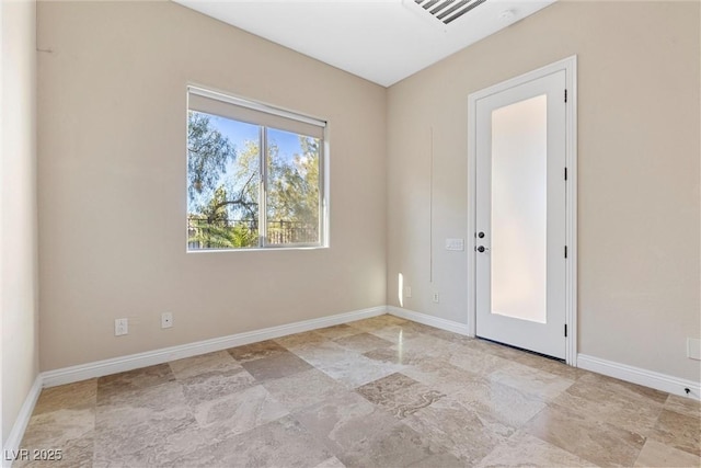 empty room featuring visible vents and baseboards