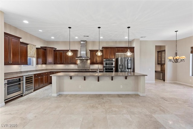 kitchen with wall chimney exhaust hood, wine cooler, appliances with stainless steel finishes, a kitchen breakfast bar, and a sink