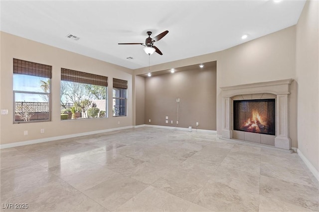 unfurnished living room with recessed lighting, visible vents, a glass covered fireplace, ceiling fan, and baseboards