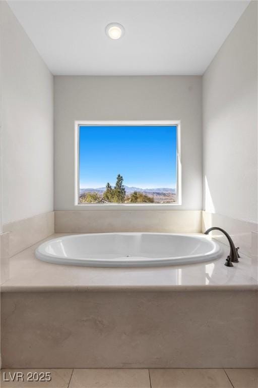 bathroom featuring a garden tub and tile patterned floors