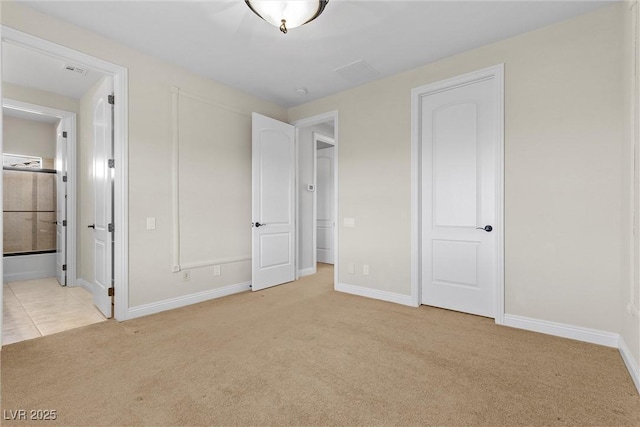 unfurnished bedroom featuring baseboards, visible vents, connected bathroom, and light colored carpet