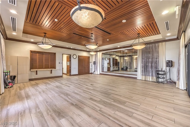 unfurnished living room with wood ceiling, visible vents, a tray ceiling, and wood finished floors