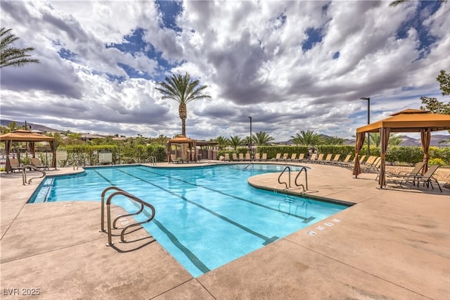 pool with a patio area and a gazebo