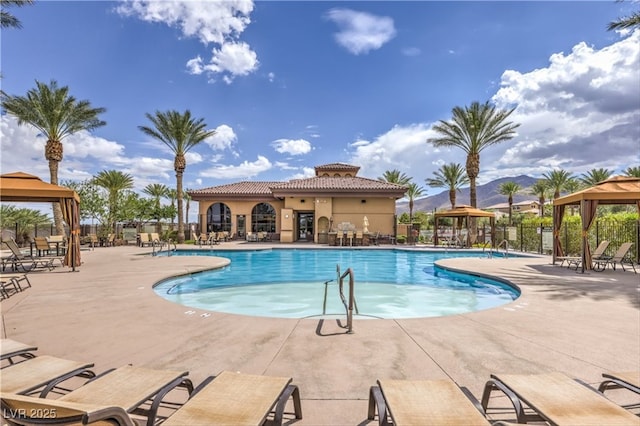 pool with a gazebo, a patio area, and fence