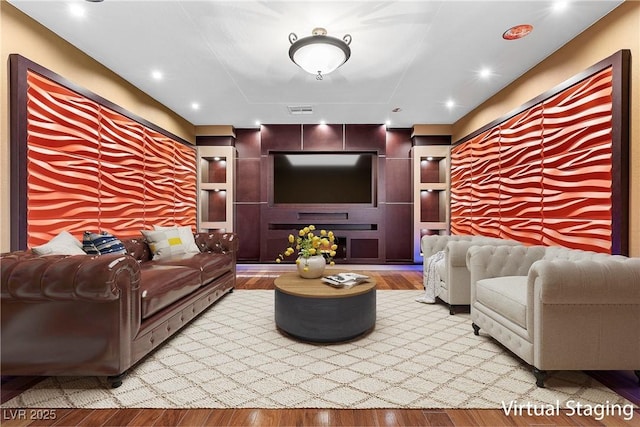 living area with light wood-style floors, recessed lighting, and visible vents