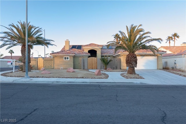 mediterranean / spanish house featuring a garage