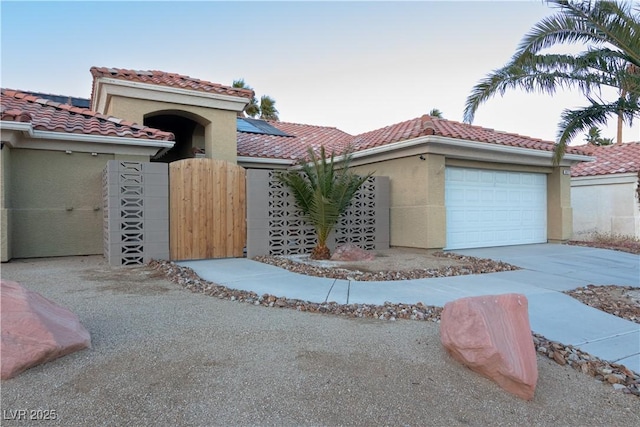 mediterranean / spanish-style home featuring a garage