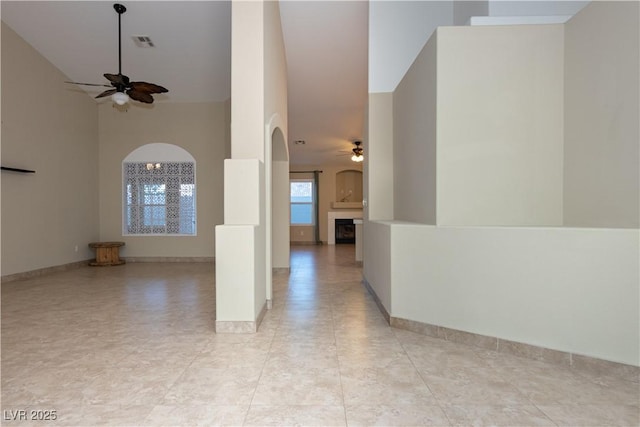 spare room with a towering ceiling and ceiling fan