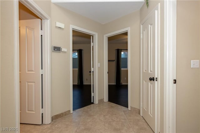 hall with light tile patterned floors