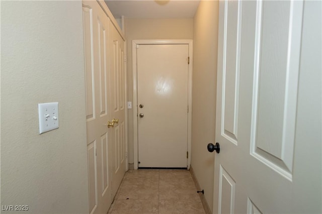 corridor with light tile patterned floors