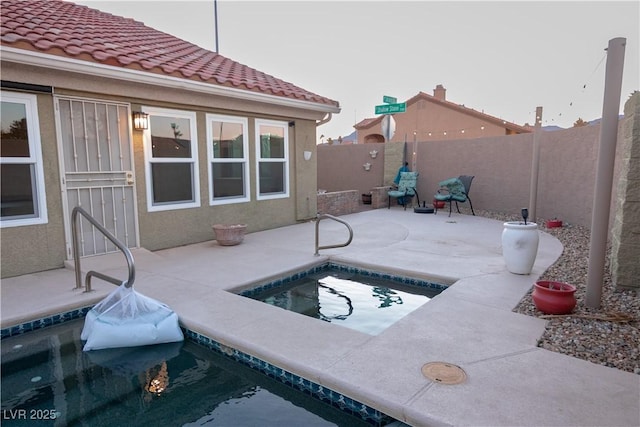 view of swimming pool featuring a hot tub