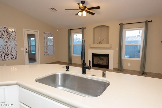 kitchen with sink, lofted ceiling, and ceiling fan