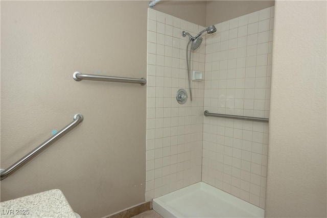 bathroom with tiled shower