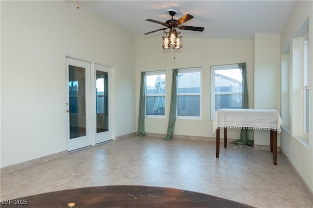 empty room with lofted ceiling and ceiling fan