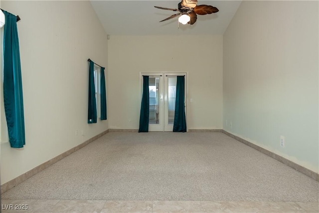 carpeted empty room featuring french doors and ceiling fan