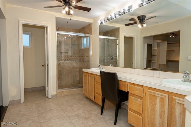 bathroom with ceiling fan, an enclosed shower, and vanity