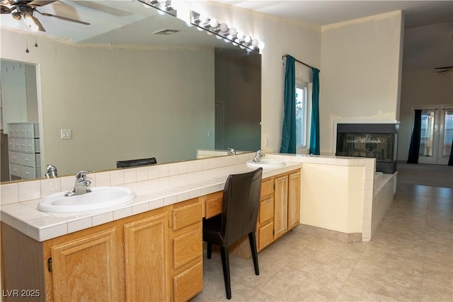 bathroom featuring ceiling fan, tile patterned flooring, and vanity