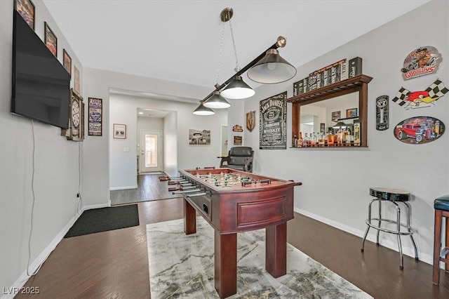 recreation room with dark wood-type flooring