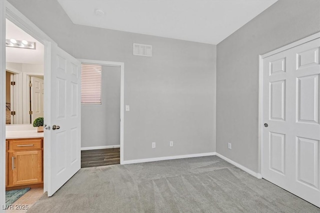 unfurnished bedroom featuring light colored carpet