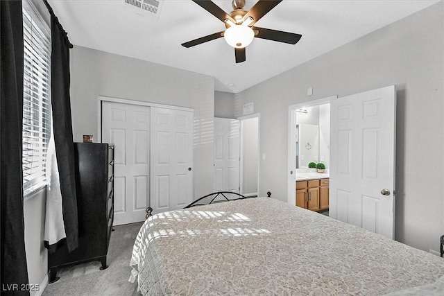 carpeted bedroom with ceiling fan, connected bathroom, and a closet