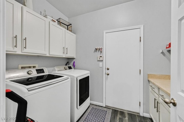 laundry area with cabinets, separate washer and dryer, and dark hardwood / wood-style flooring