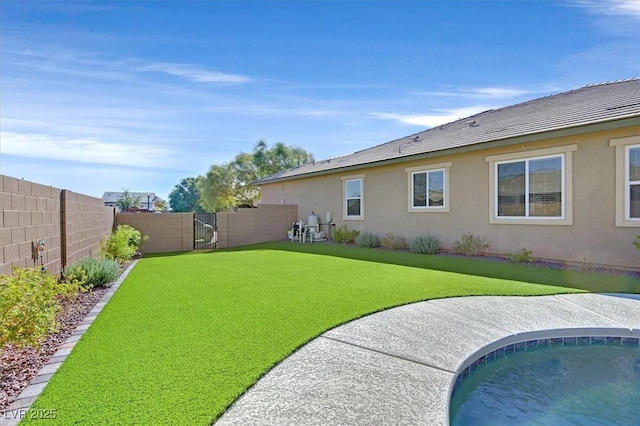 back of property featuring a fenced in pool and a lawn