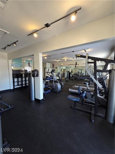 exercise room with a textured ceiling