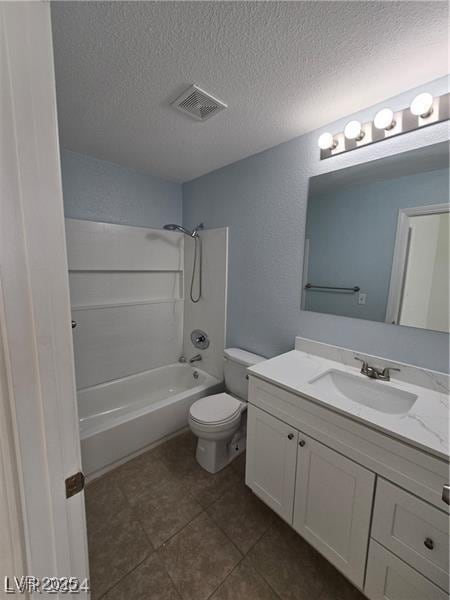 full bathroom featuring vanity, a textured ceiling, toilet, and tub / shower combination