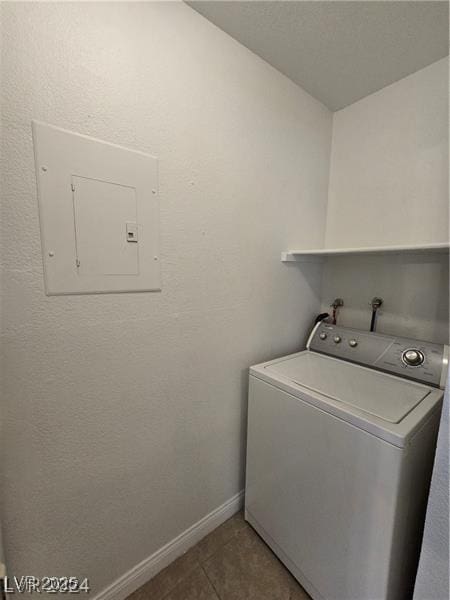 laundry room with electric panel, tile patterned flooring, and washer / dryer