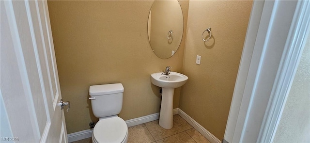 bathroom with tile patterned flooring and toilet