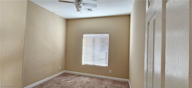 spare room with ceiling fan, plenty of natural light, and carpet