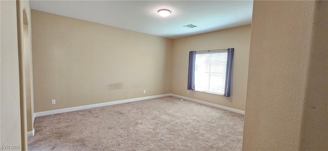 empty room with light colored carpet