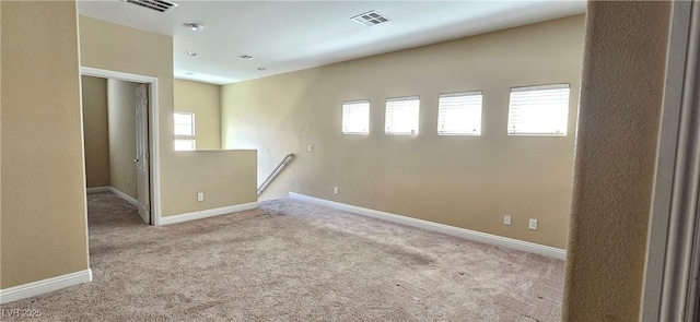 spare room featuring light carpet