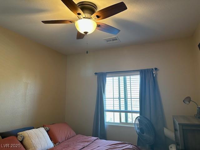 bedroom featuring a ceiling fan and visible vents