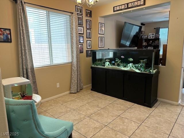 interior space with a notable chandelier, plenty of natural light, and baseboards