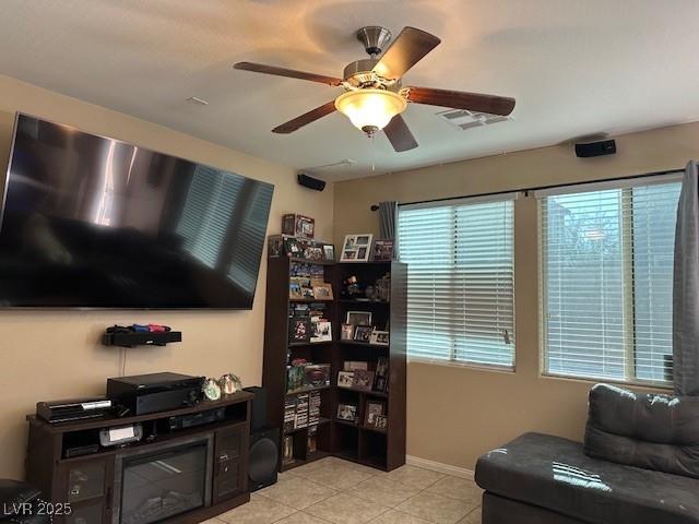 sitting room featuring light tile patterned flooring and ceiling fan