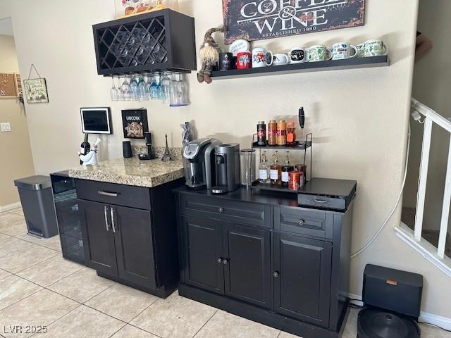 bar featuring a dry bar and light tile patterned flooring