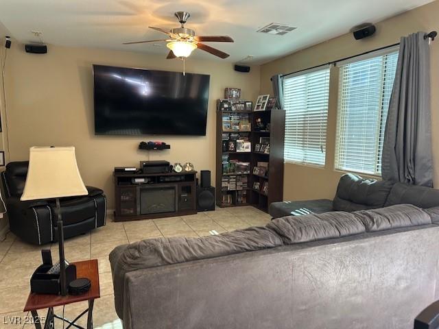 tiled living room featuring ceiling fan