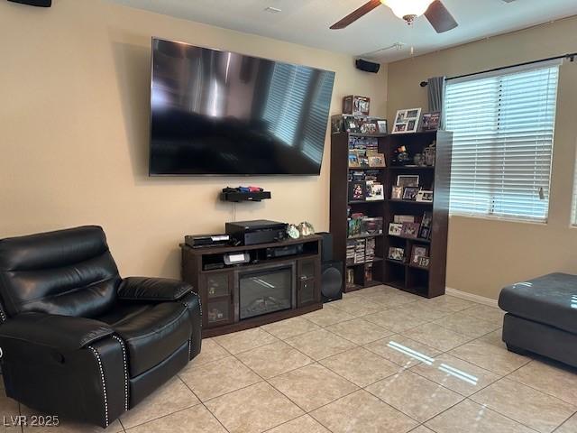 living room featuring ceiling fan and light tile patterned floors