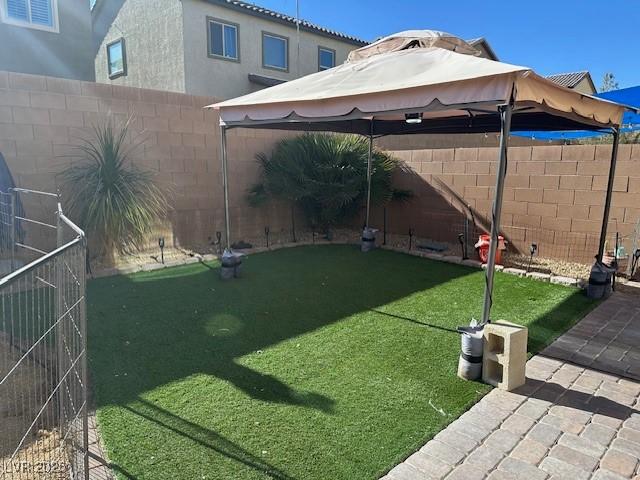 view of yard featuring a gazebo and a fenced backyard