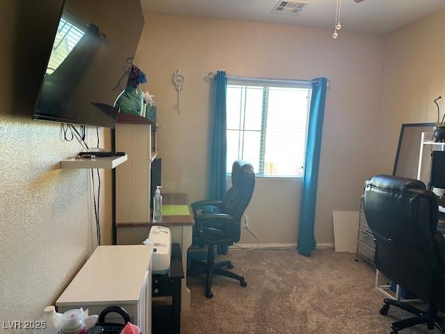 carpeted home office featuring visible vents and ceiling fan