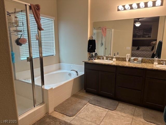 bathroom featuring vanity, independent shower and bath, and tile patterned flooring