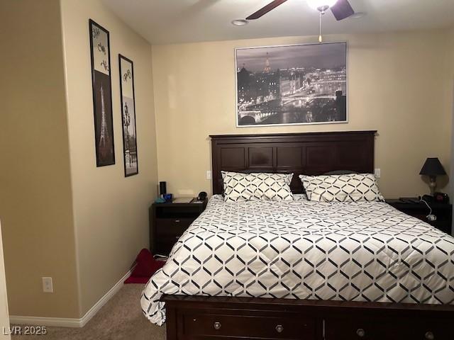 carpeted bedroom featuring ceiling fan and baseboards