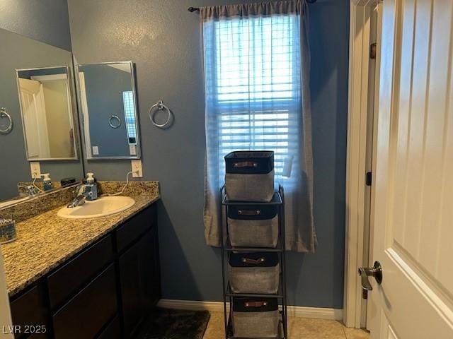 bathroom featuring a wealth of natural light, baseboards, and tile patterned flooring