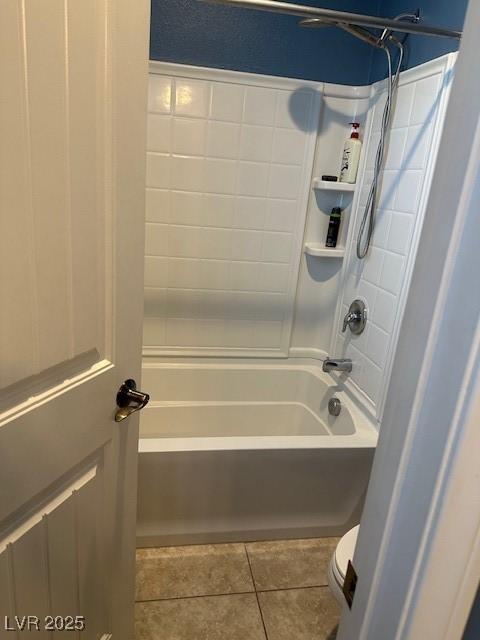 bathroom with toilet, tub / shower combination, and tile patterned flooring